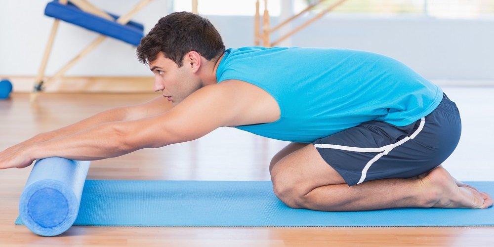 Man exercising with foam roller