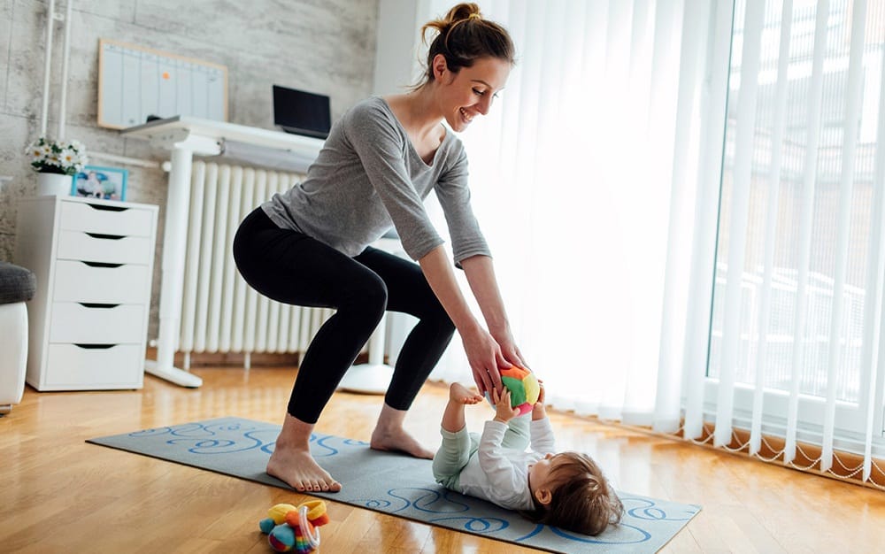 mom-working-out-in-home-with-baby